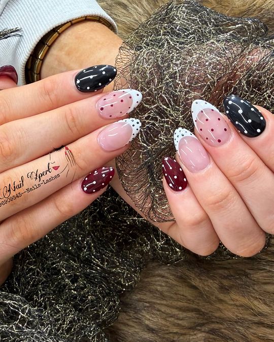 Almond nails in black, burgundy and white French tips with small polka dots