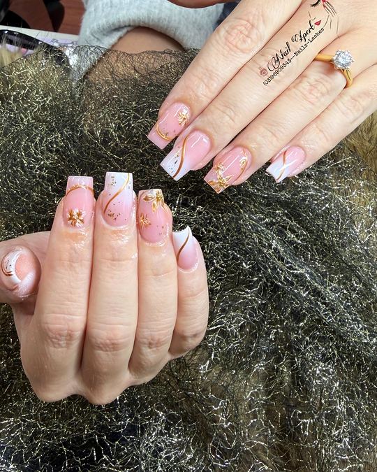 Square nails in pink ombre with white tips, gold swirls and tiny gold flowers